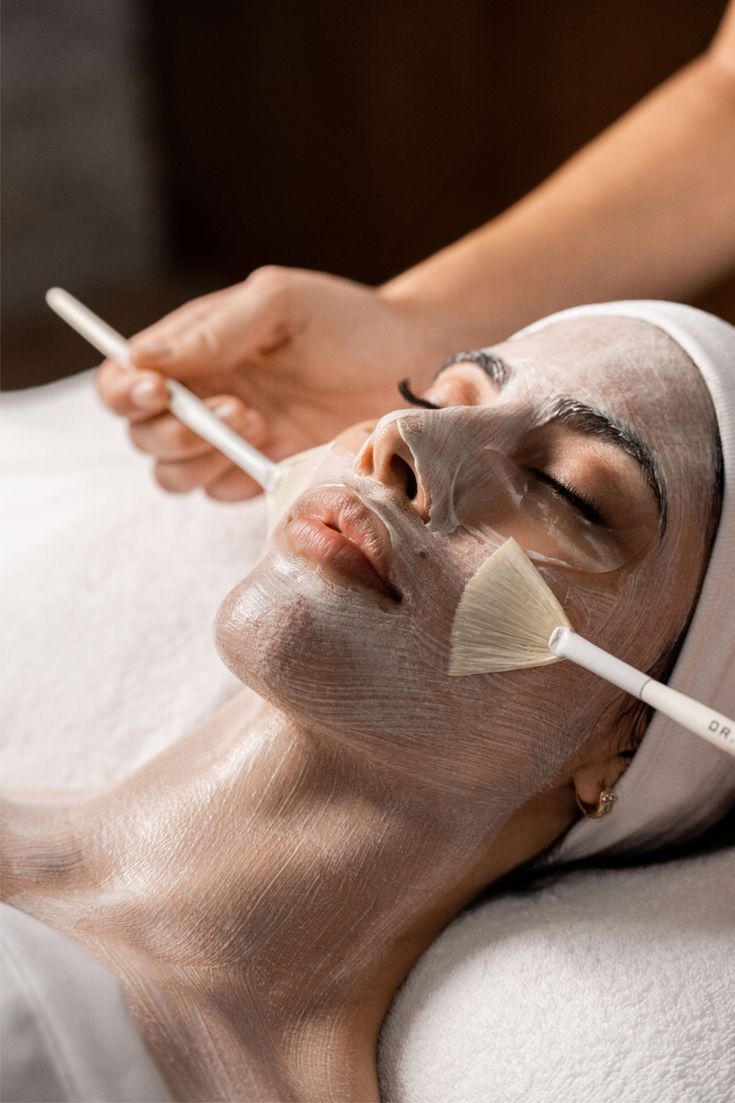Facial mask applied with a fan brush during a skin ritual